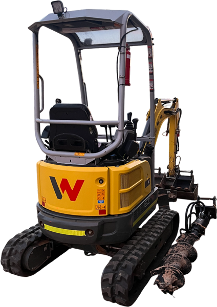 Yellow mini excavator with an auger attachment